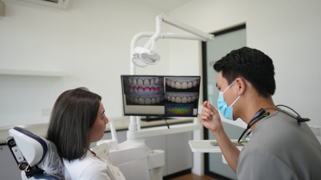 Dentist and patient reviewing digital Smile Design and Veneers planning on screen at Serene Smile Dental Clinic.